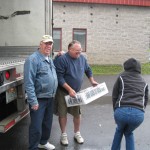 Helpers unload grapes.2580